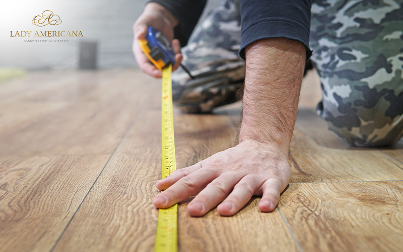 A man measuring floor size